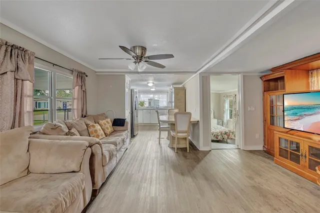 a living room with furniture wooden floor and a flat screen tv