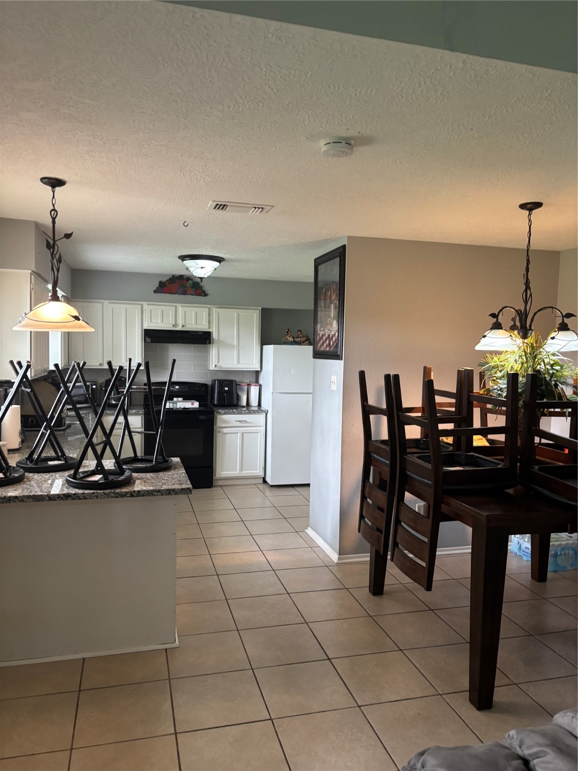 22223 Spring Gate Drive Spring, TX 77373 - Photo 6 of 15 a kitchen with stainless steel appliances a table and chairs in it