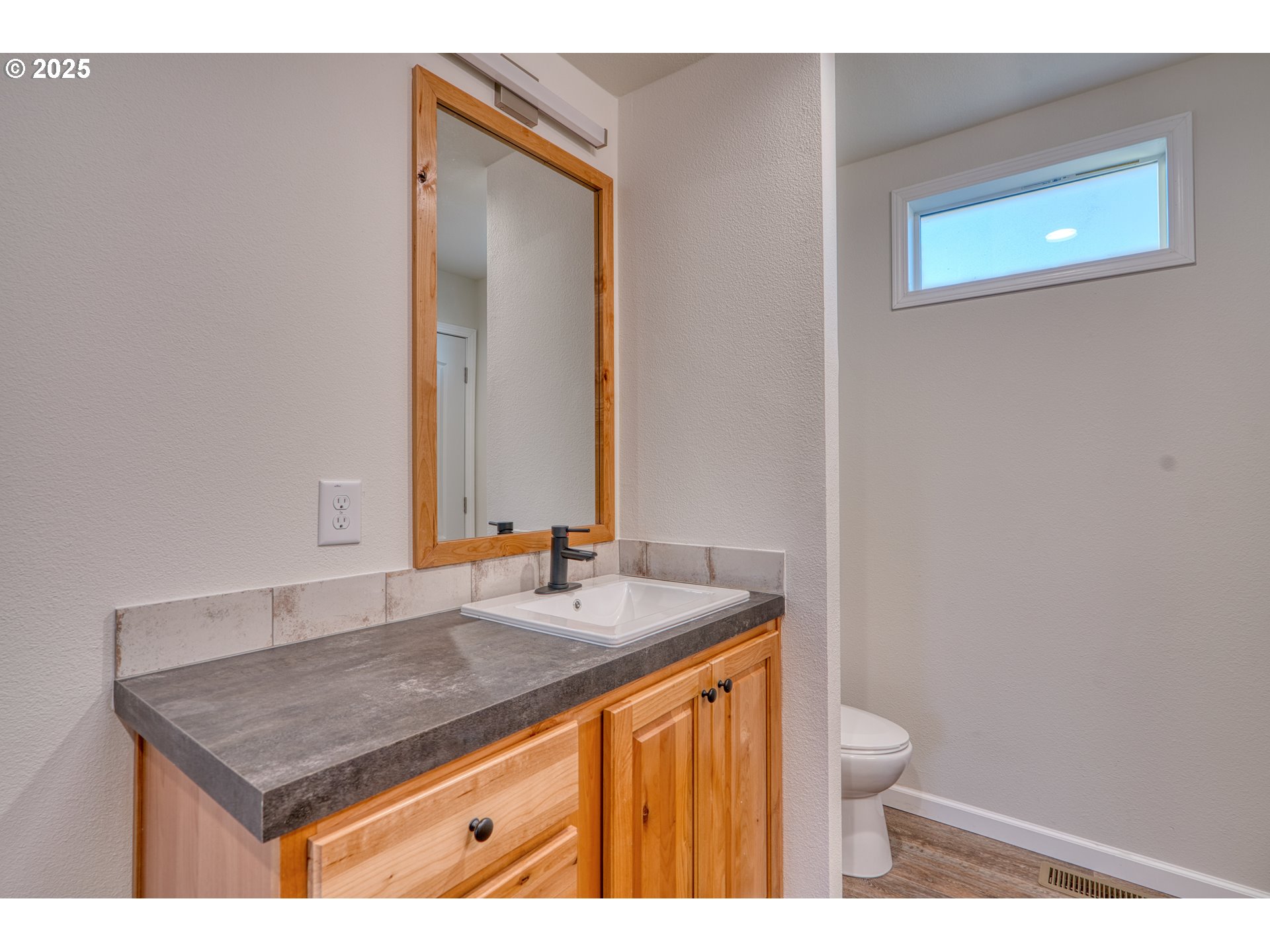 959 High Prairie Road Lyle, WA 98635 - Photo 28 of 34 a bathroom with a granite countertop sink and a toilet