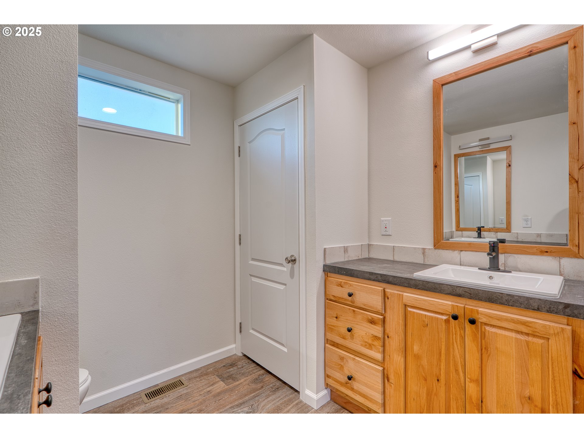 959 High Prairie Road Lyle, WA 98635 - Photo 29 of 34 a bathroom with a granite countertop sink and a mirror