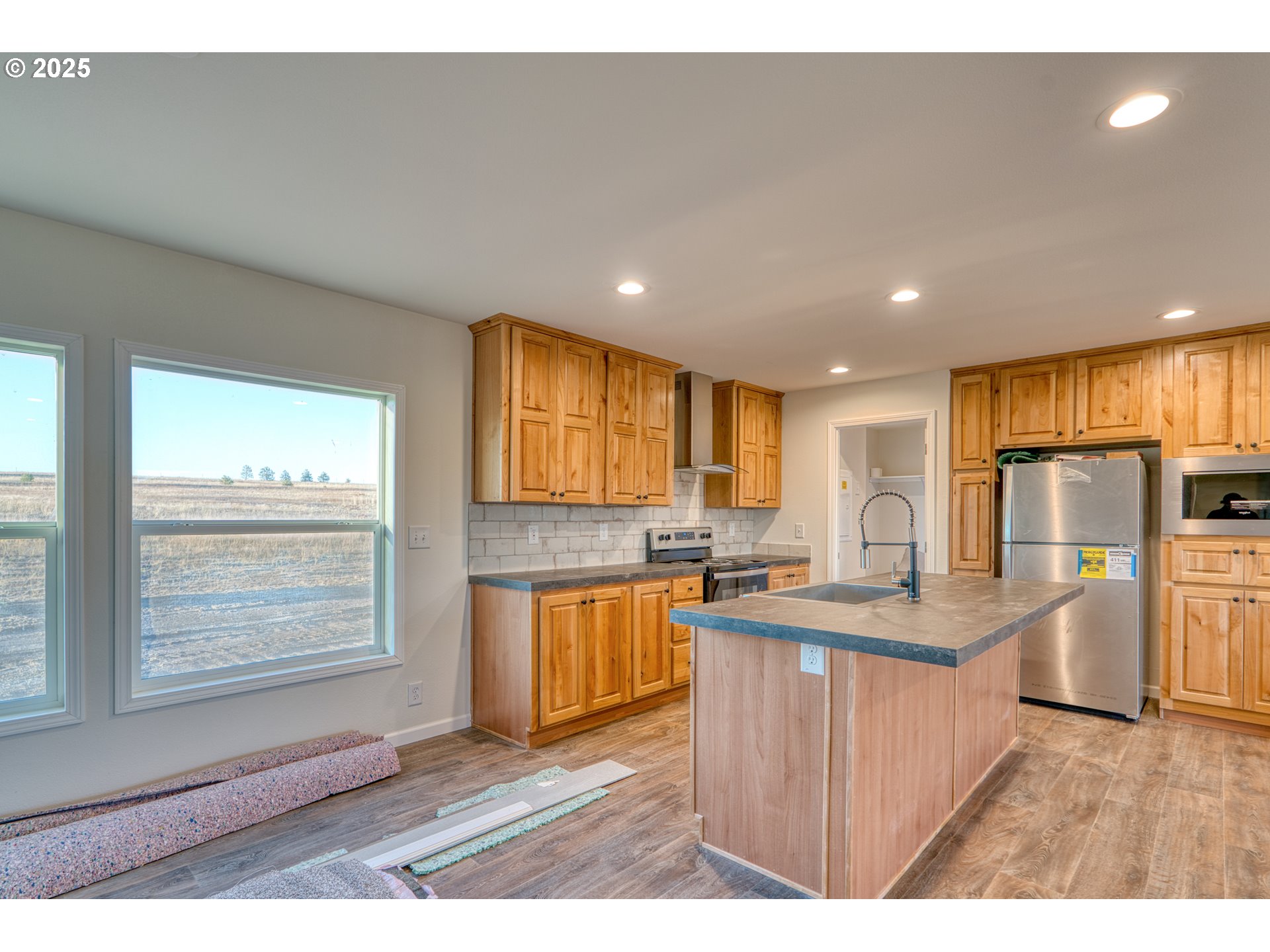 959 High Prairie Road Lyle, WA 98635 - Photo 7 of 34 a kitchen with stainless steel appliances granite countertop a sink stove and refrigerator