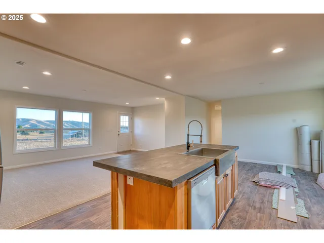 a kitchen that has a sink a stove counter space and a sink