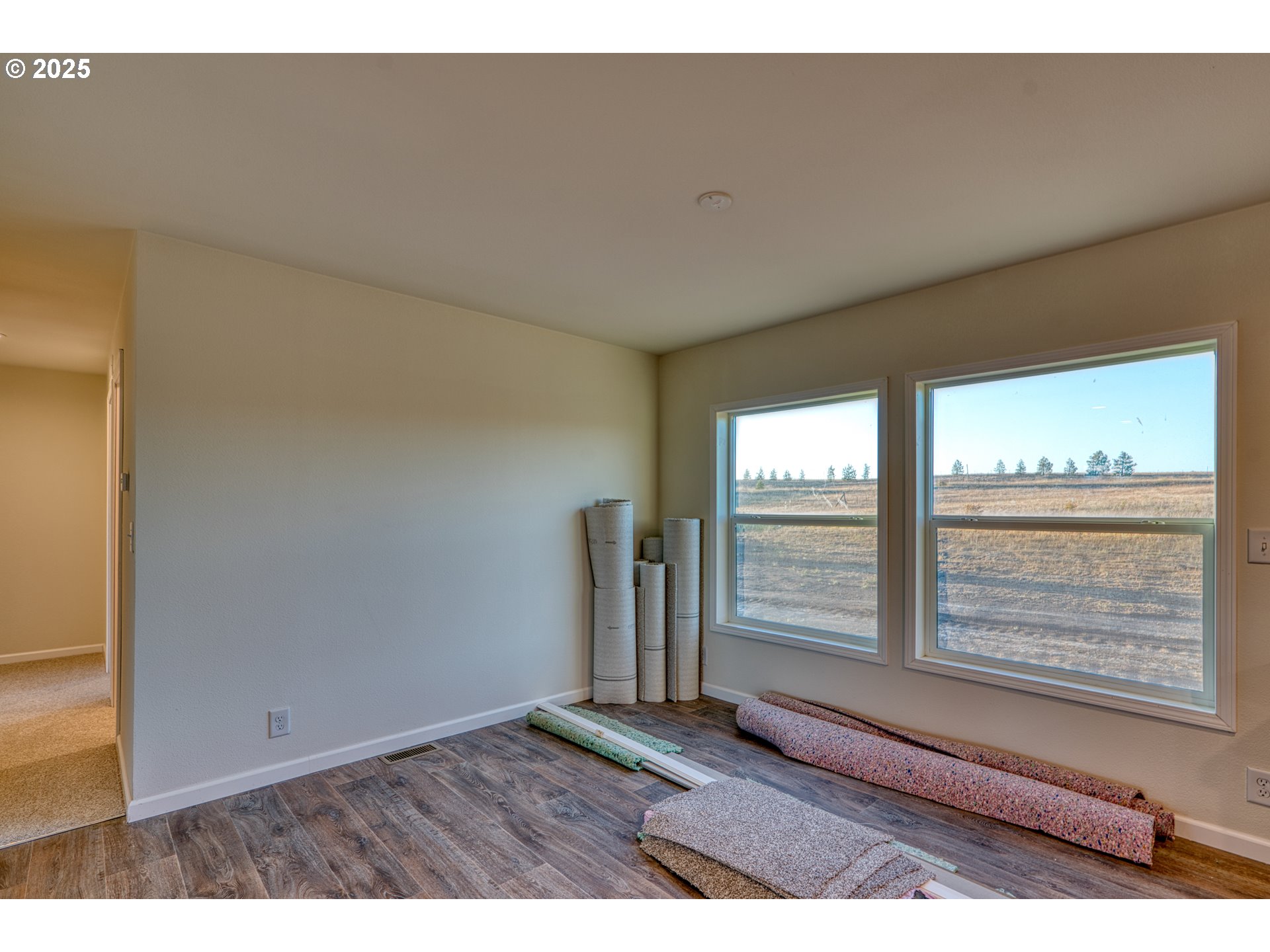 959 High Prairie Road Lyle, WA 98635 - Photo 10 of 34 a view of empty room with wooden floor and fan