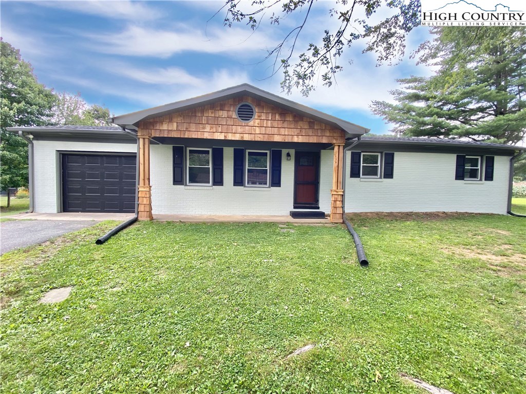 272 Clint Lewis Road Boone, NC 28607 - Photo 1 of 32 a front view of house with yard and garage