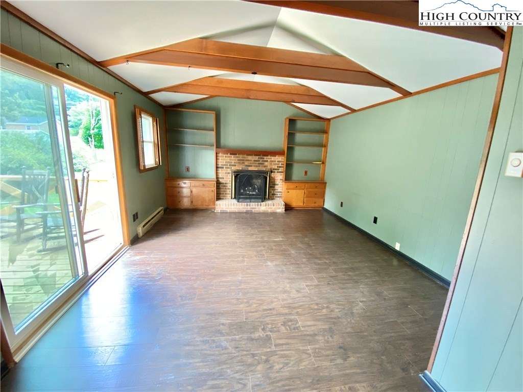 272 Clint Lewis Road Boone, NC 28607 - Photo 15 of 32 a view of an empty room with a fireplace and a window