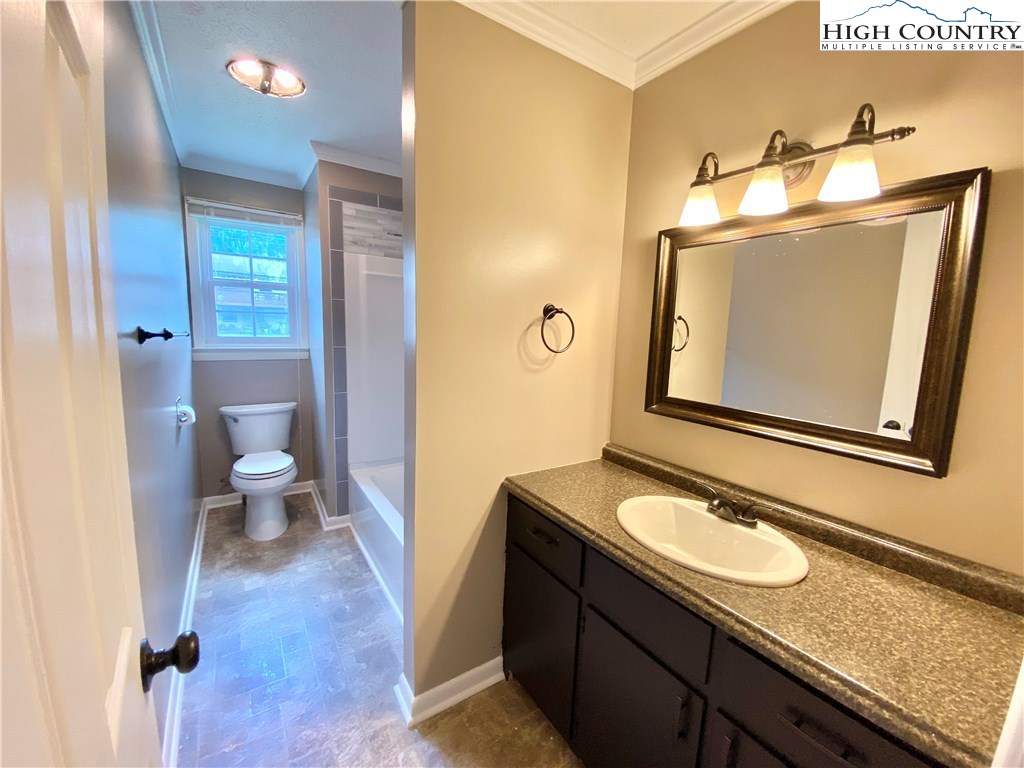 272 Clint Lewis Road Boone, NC 28607 - Photo 20 of 32 a bathroom with a granite countertop sink and a mirror