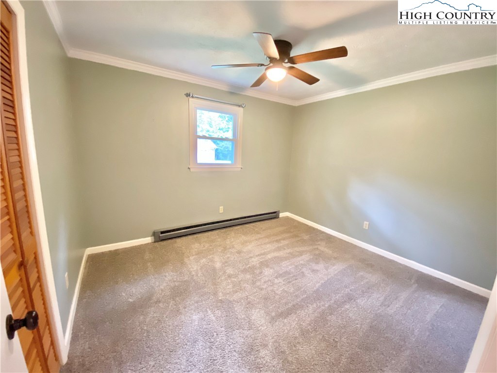 272 Clint Lewis Road Boone, NC 28607 - Photo 22 of 32 an empty room with a ceiling fan and window