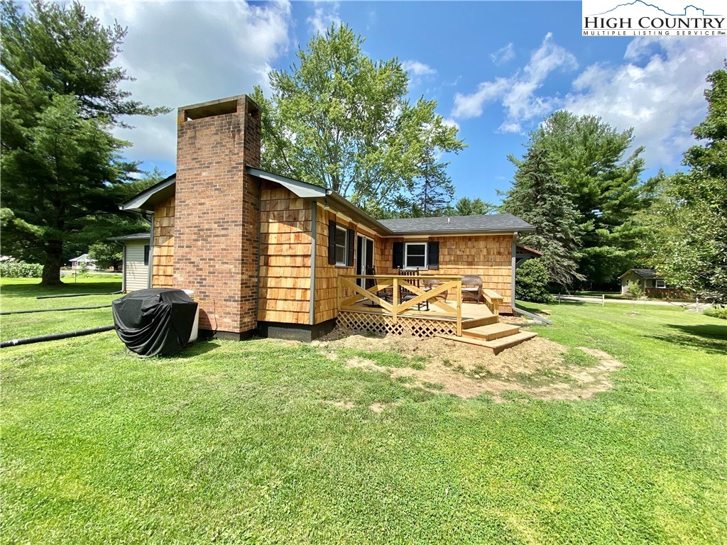 272 Clint Lewis Road Boone, NC 28607 - Photo 28 of 32 a view of a house with backyard and chairs