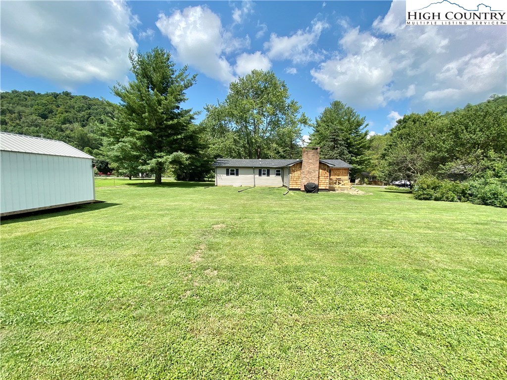 272 Clint Lewis Road Boone, NC 28607 - Photo 30 of 32 a view of a big yard with an outdoor seating and house