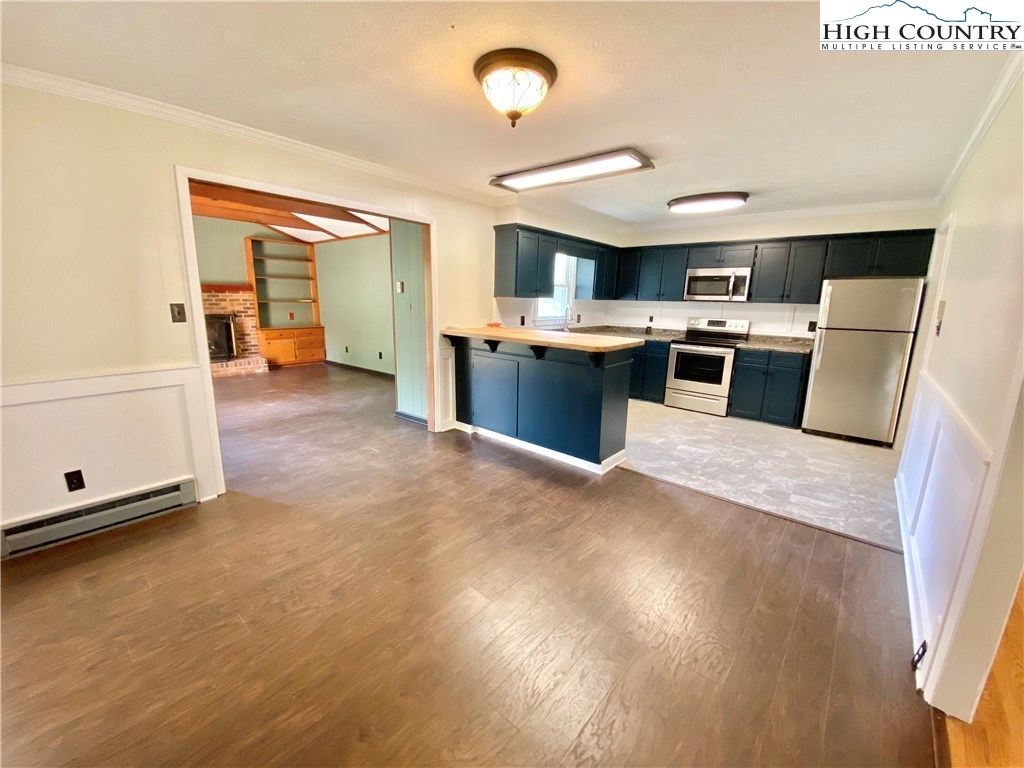 272 Clint Lewis Road Boone, NC 28607 - Photo 8 of 32 a view of a kitchen with wooden floor