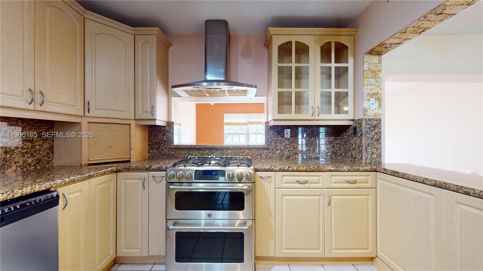 6051 Southwest 110th Avenue Miami, FL 33173 - Photo 11 of 49 a kitchen with stainless steel appliances granite countertop a stove and a cabinets