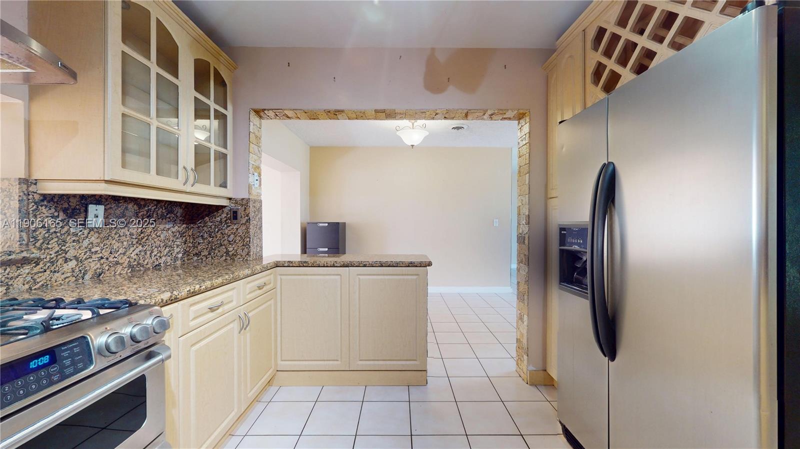 6051 Southwest 110th Avenue Miami, FL 33173 - Photo 12 of 49 a kitchen with stainless steel appliances granite countertop a refrigerator and a stove