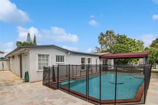 a view of a house with wooden fence