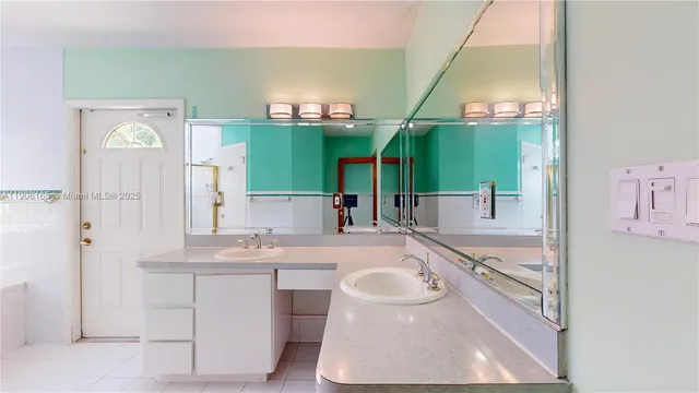 a bathroom with a sink mirror and shower