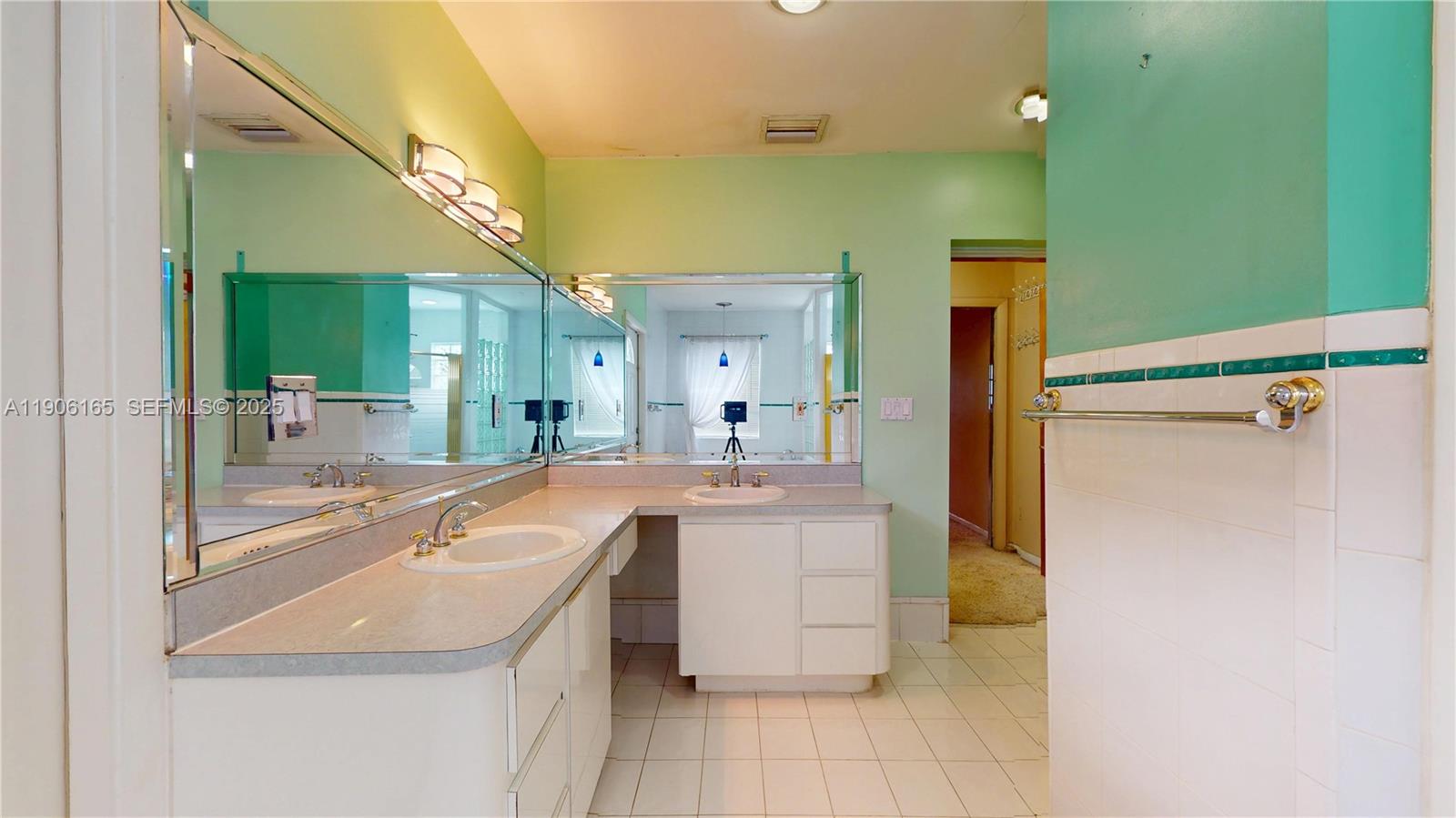 6051 Southwest 110th Avenue Miami, FL 33173 - Photo 26 of 49 a room with a sink a washer and dryer