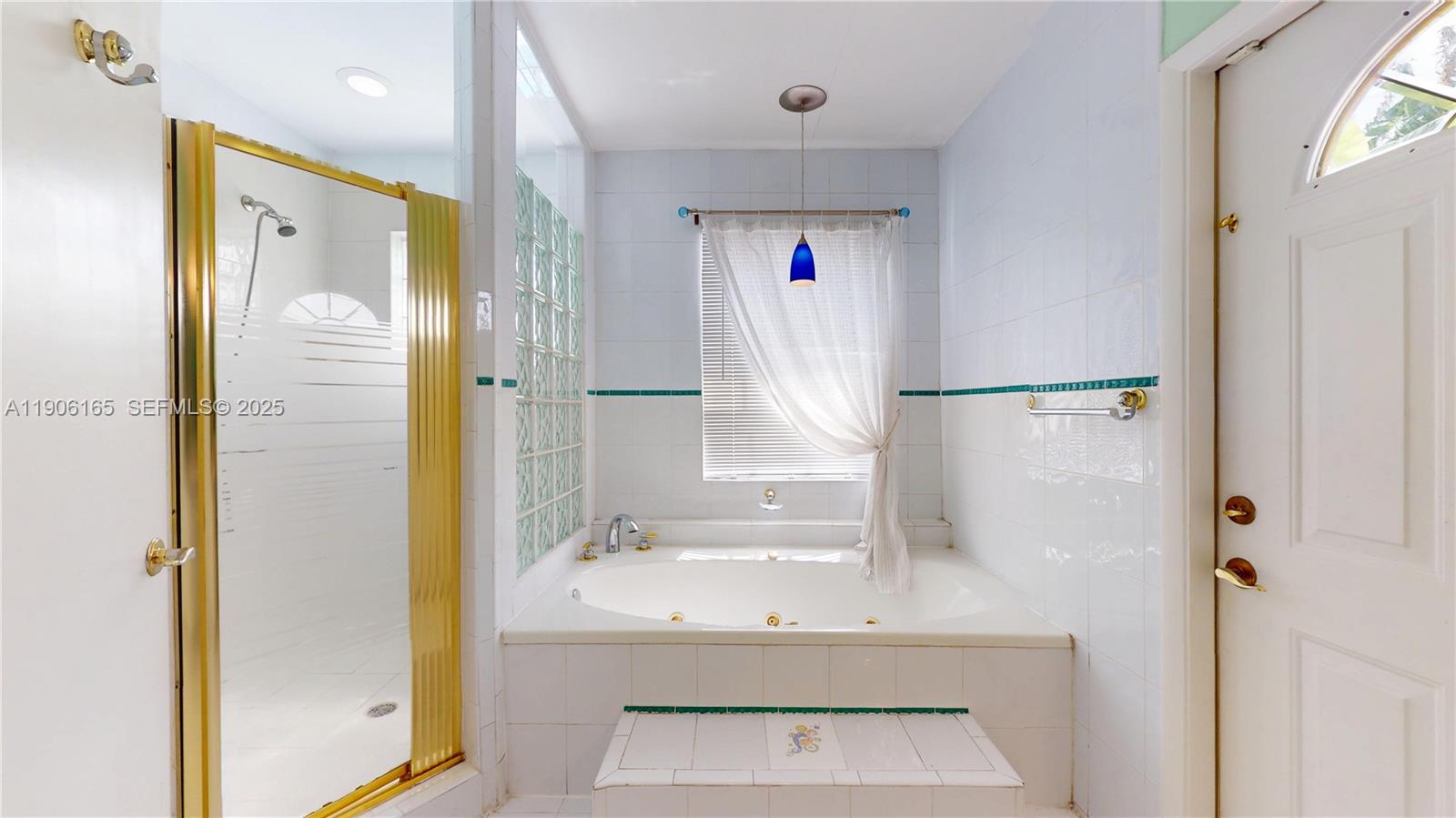 6051 Southwest 110th Avenue Miami, FL 33173 - Photo 27 of 49 a bathroom with a sink mirror and shower