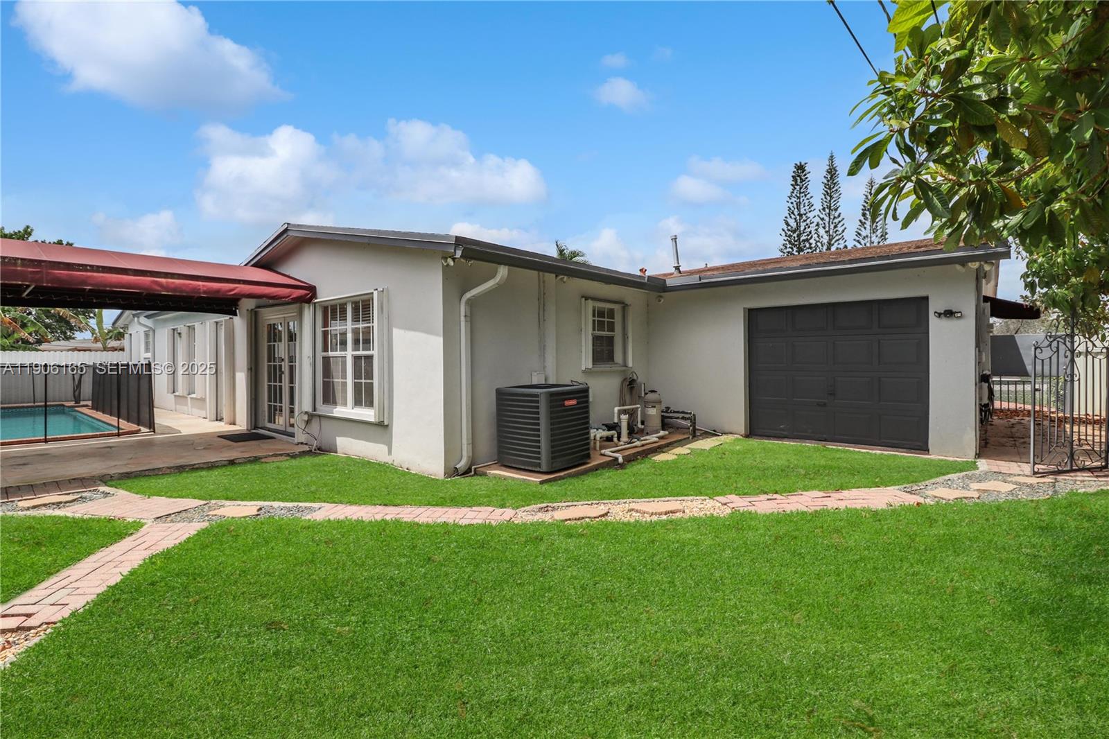 6051 Southwest 110th Avenue Miami, FL 33173 - Photo 3 of 49 a view of a house with a yard and garage