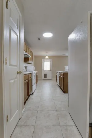 a large kitchen with cabinets and stainless steel appliances
