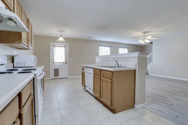 a kitchen with stainless steel appliances granite countertop a stove and a sink