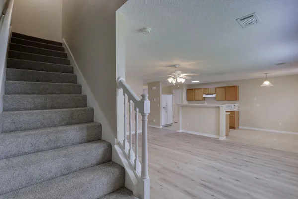 a view of entryway and hall with wooden floor