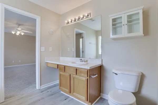 a bathroom with a toilet a sink and mirror