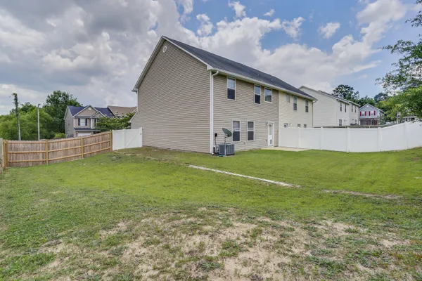 a view of a house with a yard and pathway