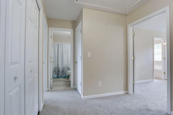 a view of a hallway with an empty room and closet