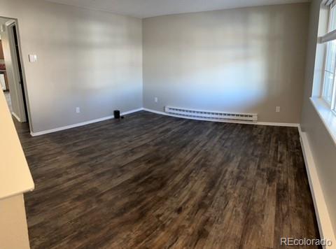 1976 Eagle Street Aurora, CO 80011 - Photo 3 of 14 an empty room with wooden floor and windows