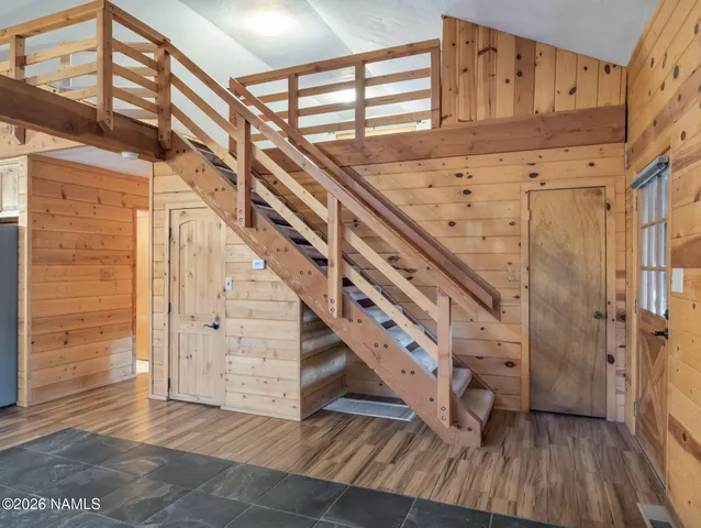 a view of a room with wooden floor