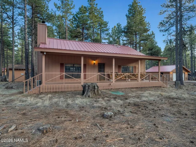 a view of a house with a patio and a yard
