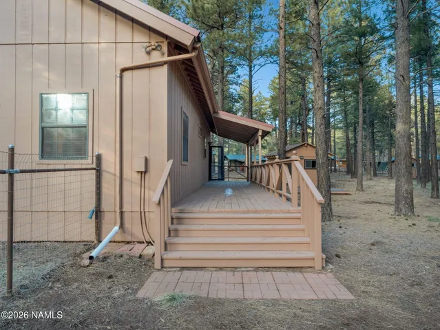 a view of a house with a yard and wooden fence