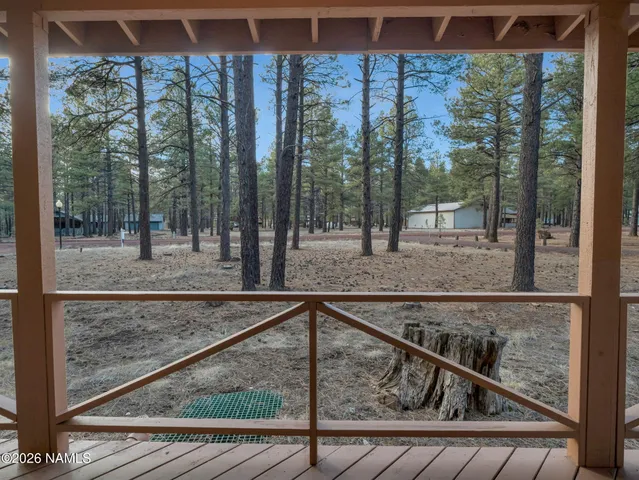 a view of a balcony with a floor to ceiling window next to a yard