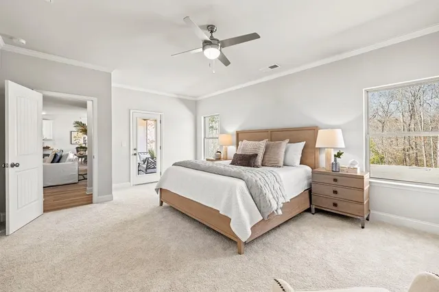 a spacious bedroom with a bed and a chandelier
