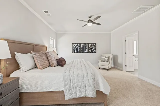 a bedroom with a large bed and a chandelier