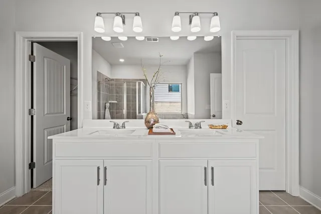 a bathroom with a sink vanity and mirror