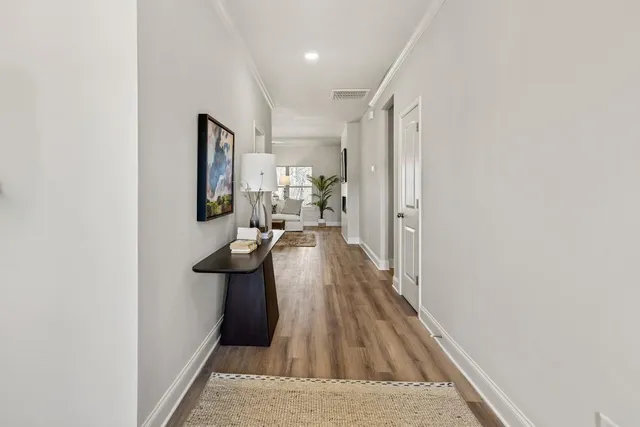 a view of a living room with furniture and wooden floor