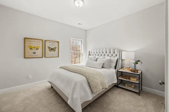 a bedroom with a bed and a painting on the wall