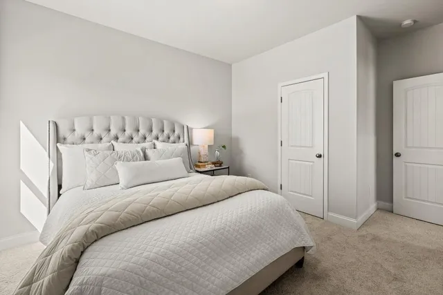 a large white bed in a white room