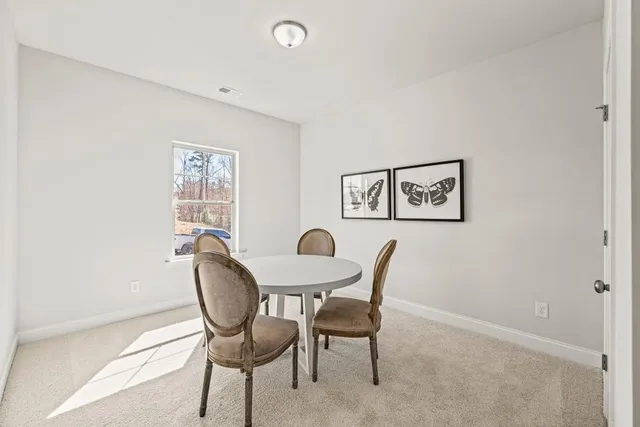 a view of a dining room with furniture and a window