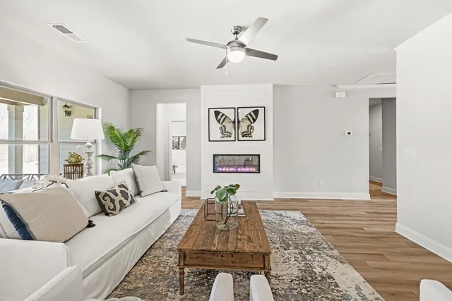 a living room with furniture and wooden floor