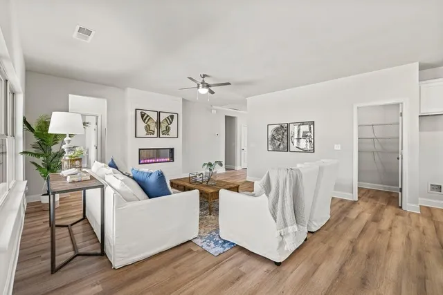 a living room with furniture and wooden floor