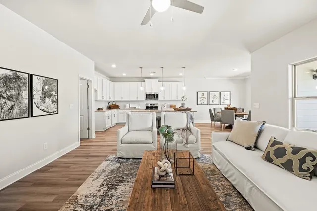 a living room with furniture and kitchen view