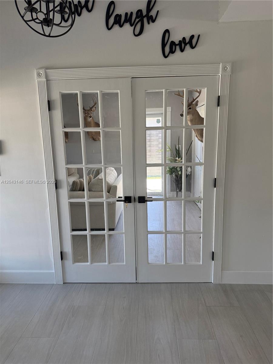 4947 Southwest 143rd Avenue Miami, FL 33175 - Photo 3 of 19 The recreational room entrance to the left of the house entrance.