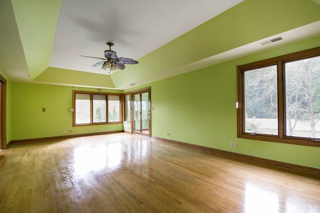 1901 East Burville Road Crete, IL 60417 - Photo 17 of 39 a view of an empty room with a window and wooden floor