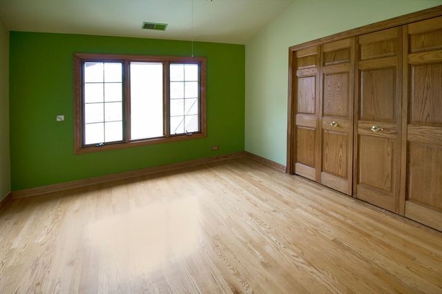 1901 East Burville Road Crete, IL 60417 - Photo 28 of 39 a view of an empty room with wooden floor and a window