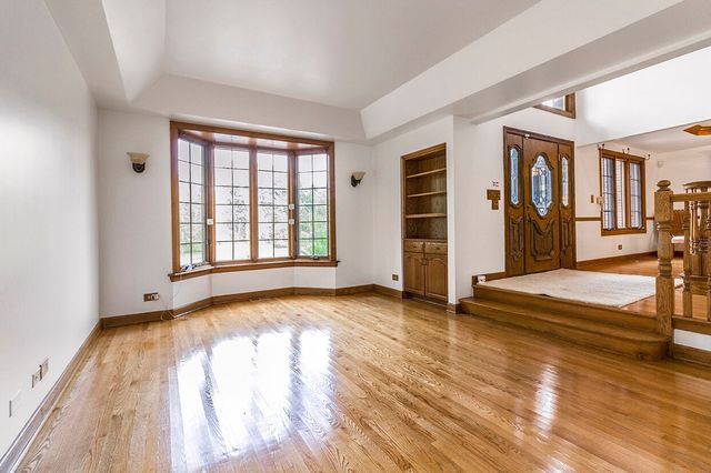 1901 East Burville Road Crete, IL 60417 - Photo 7 of 39 an empty room with wooden floor and windows