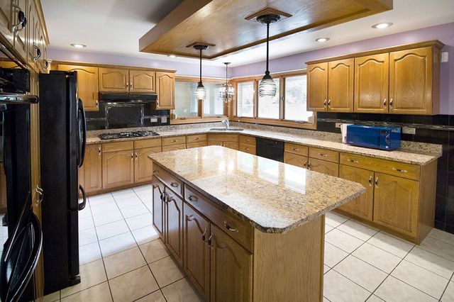 1901 East Burville Road Crete, IL 60417 - Photo 8 of 39 a kitchen with a sink a counter top space cabinets and stainless steel appliances