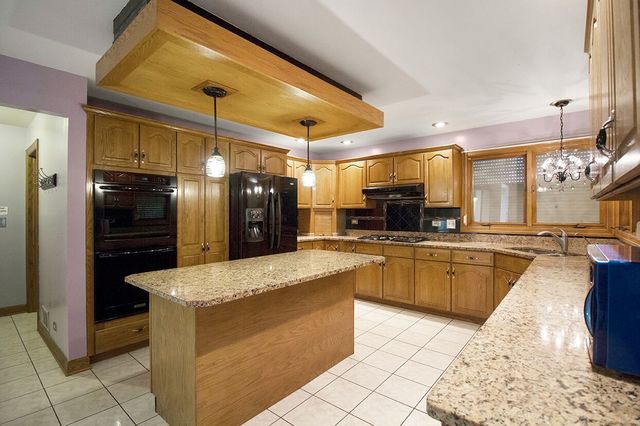 1901 East Burville Road Crete, IL 60417 - Photo 10 of 39 a large kitchen with a large counter top appliances and cabinets