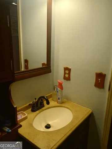 a bathroom with a sink and a mirror