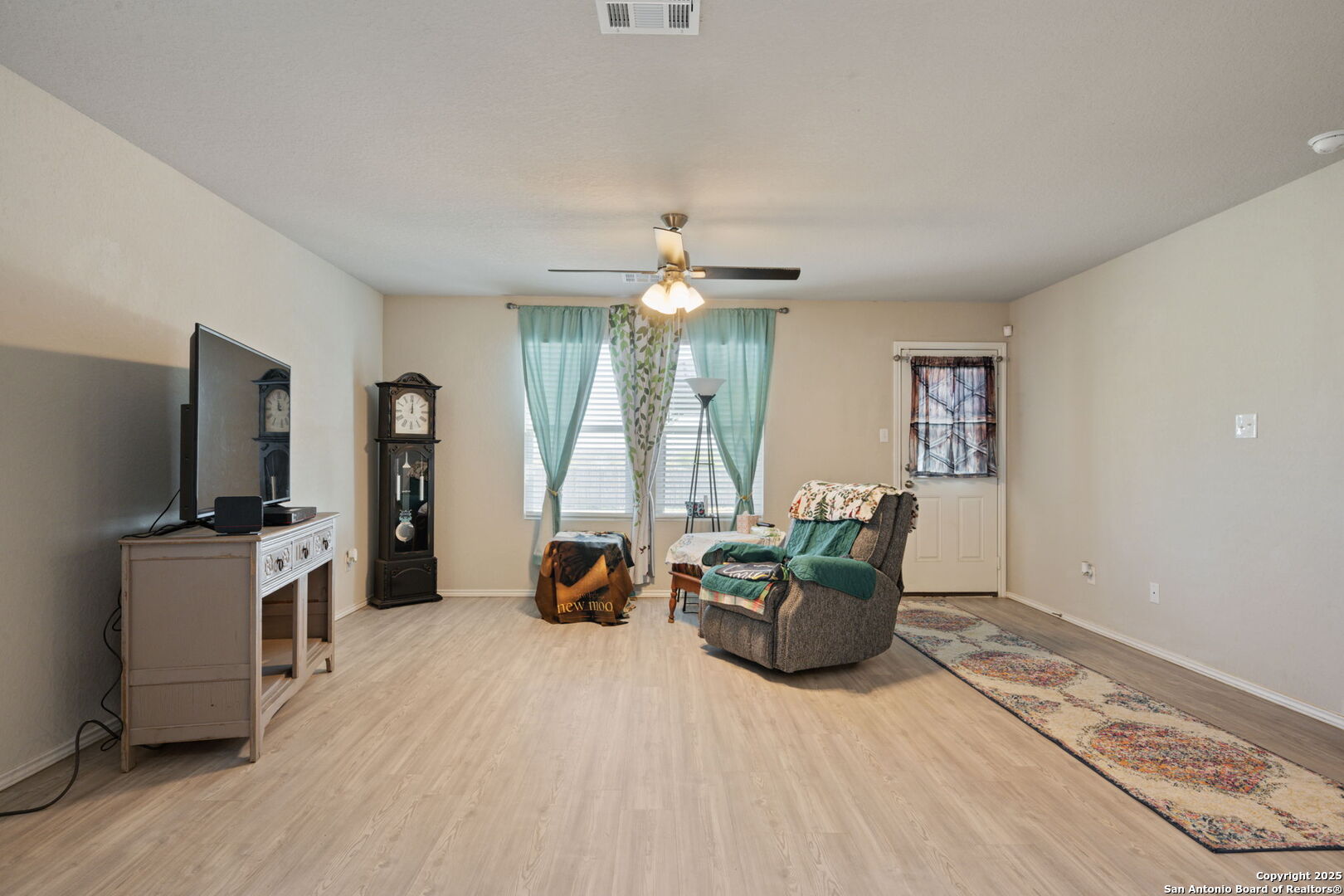439 Agave Circle Jourdanton, TX 78026 - Photo 11 of 27 a living room with furniture and a flat screen tv